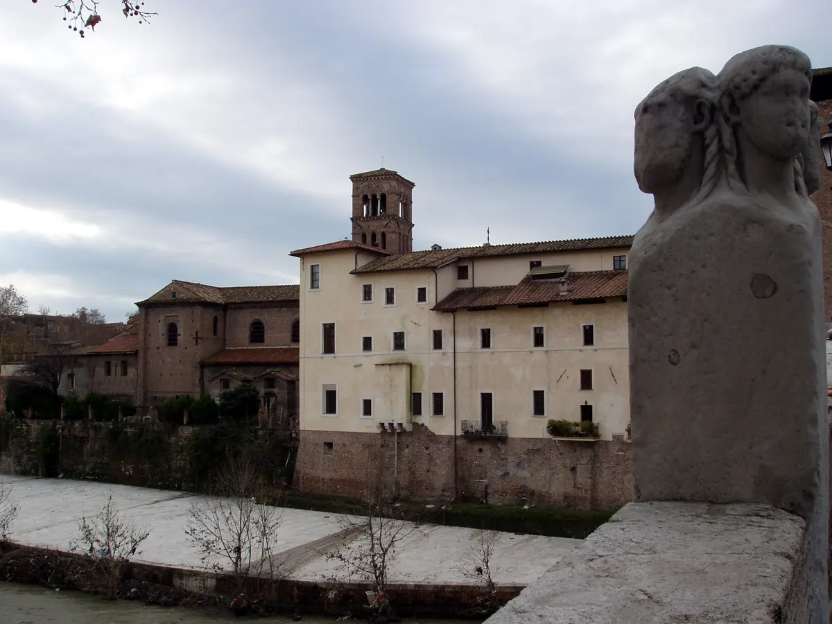Tiber Island seen from the Ponte Fabricio: the buildings of the island with the bell tower of San Bartolomeo, and a four-headed stone herm at the right